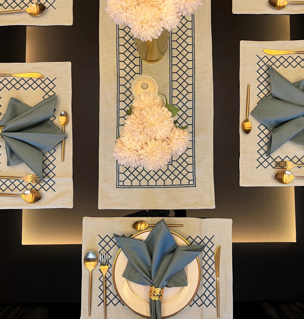 Elegant table linen set with zigzag and sage napkins.